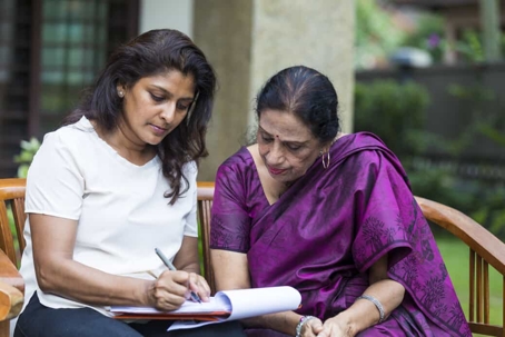 Young woman goes over estate planning documents with her mother
