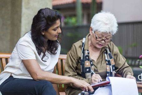 Young woman goes over paperwork with her elder