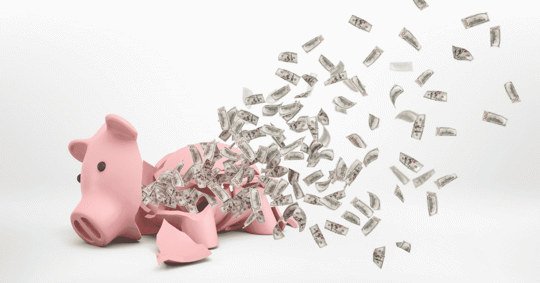 broken piggy bank with money flying out