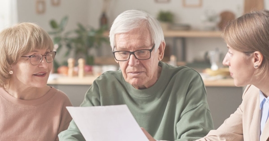 an older couple going over a will with a younger person