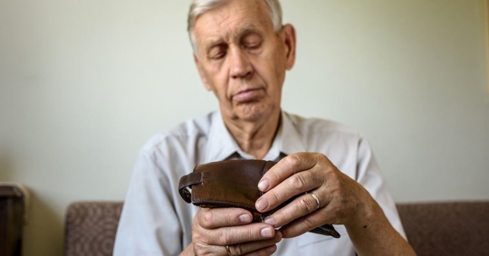 old man opening his wallet