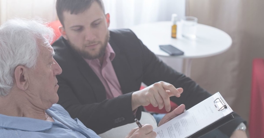attorney helping elderly man review will