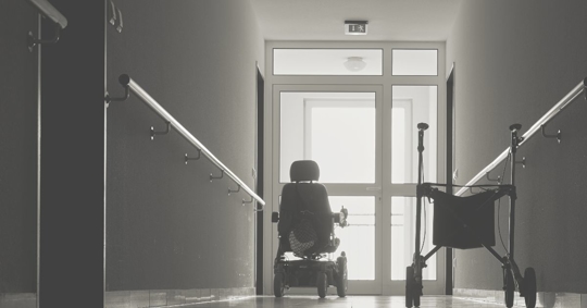 a wheel chair and a walker in a nursing home
