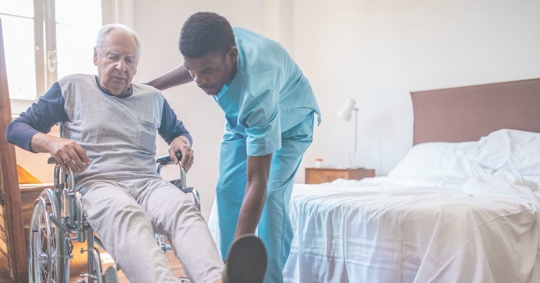 nursing helping old man in wheel chair
