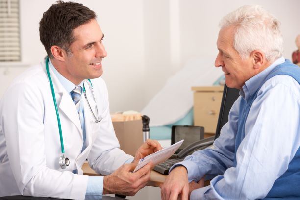 elderly man talking to a doctor